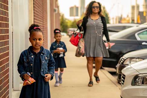  Parent walking with children